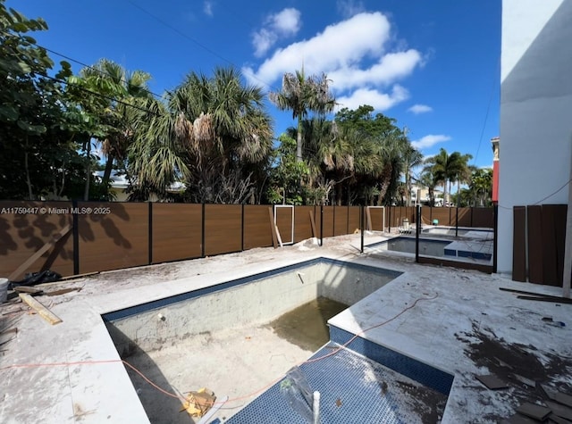 view of pool featuring a patio area, a fenced backyard, and a fenced in pool