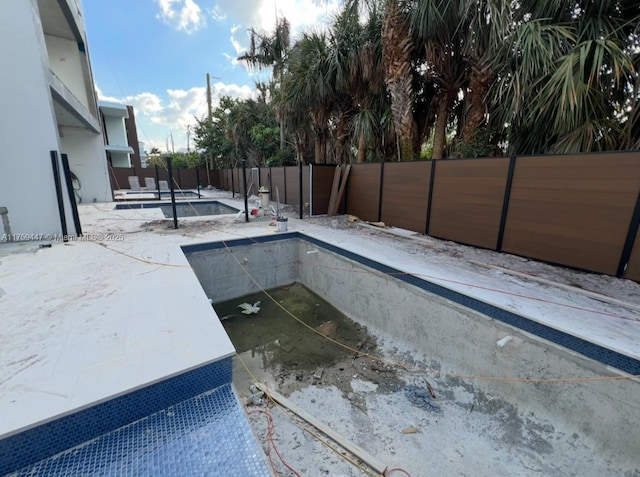 view of swimming pool featuring a fenced backyard, a fenced in pool, and a patio