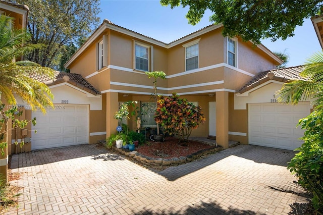 view of front of home with decorative driveway and stucco siding