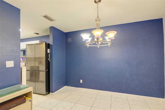 interior space with tile patterned floors, visible vents, and an inviting chandelier