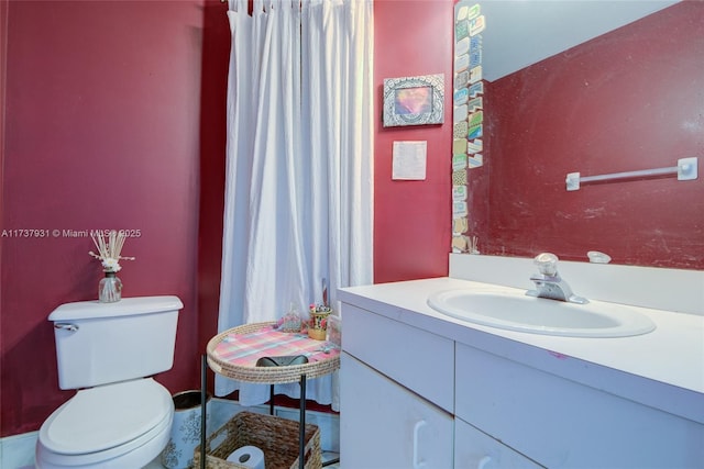 bathroom featuring toilet and vanity