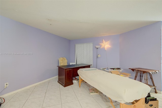 interior space featuring baseboards and light tile patterned flooring