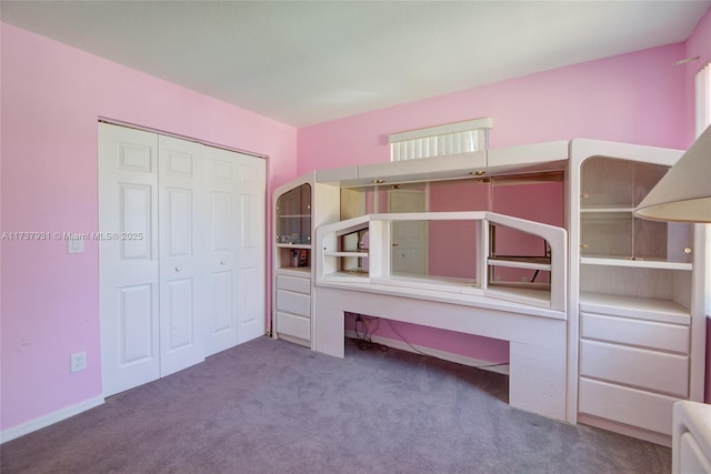 unfurnished bedroom featuring a closet and carpet flooring