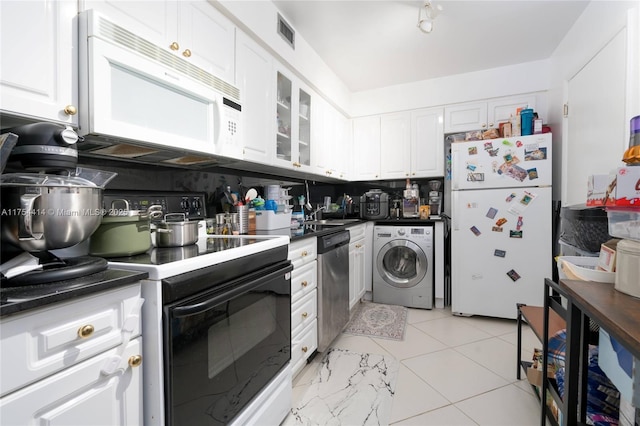 kitchen with white appliances, white cabinets, decorative backsplash, washer / clothes dryer, and dark countertops