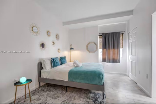 bedroom featuring baseboards and wood finished floors