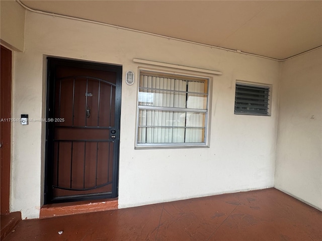 property entrance with stucco siding