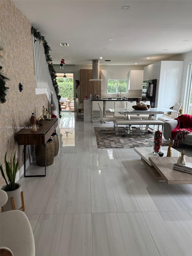 living room with a healthy amount of sunlight and visible vents