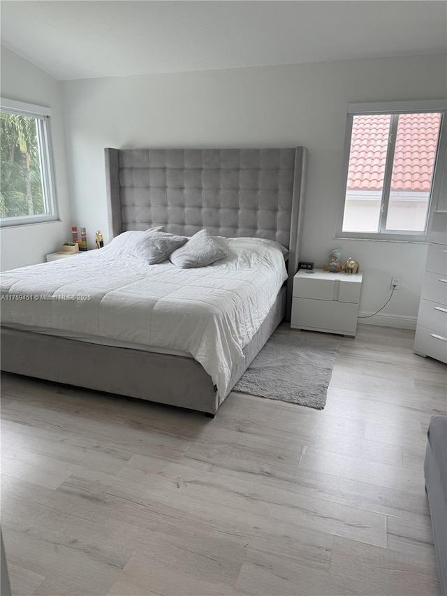 bedroom with baseboards and wood finished floors