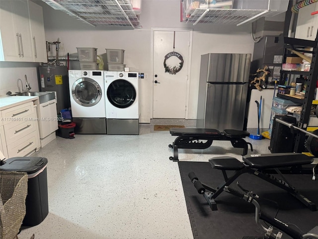 interior space with cabinet space, a sink, electric water heater, and washer and dryer