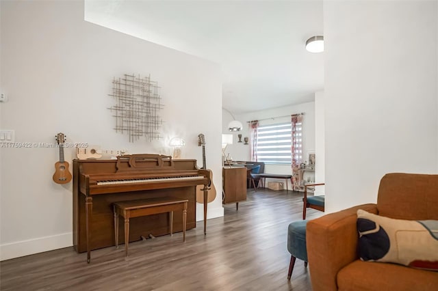 living area featuring baseboards and wood finished floors