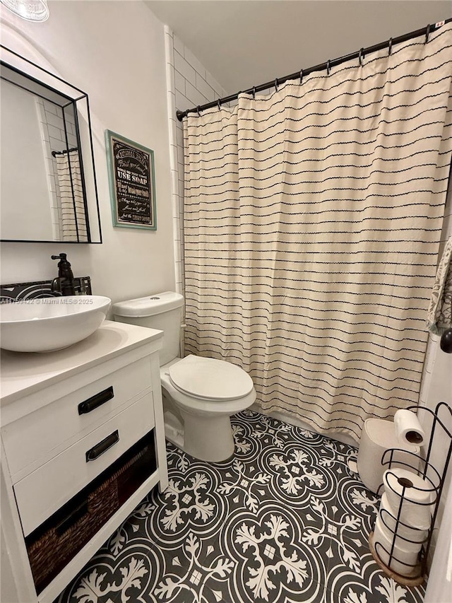 full bath with vanity, curtained shower, tile patterned flooring, and toilet