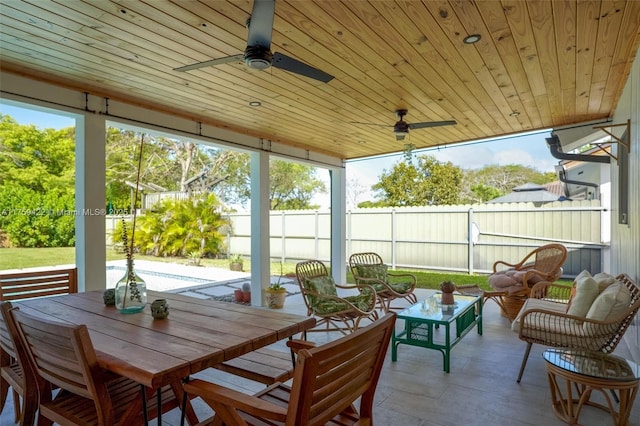 sunroom featuring ceiling fan and wooden ceiling