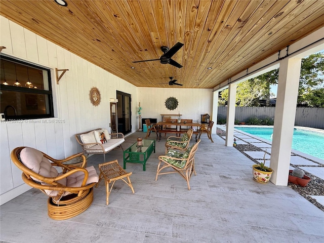 view of patio / terrace with a fenced in pool, fence, an outdoor living space, and a ceiling fan