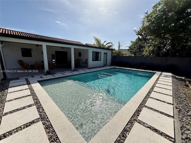 view of pool featuring ceiling fan, a patio area, a fenced backyard, and a fenced in pool