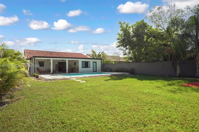 rear view of house featuring a fenced in pool, a patio, a lawn, a ceiling fan, and a fenced backyard