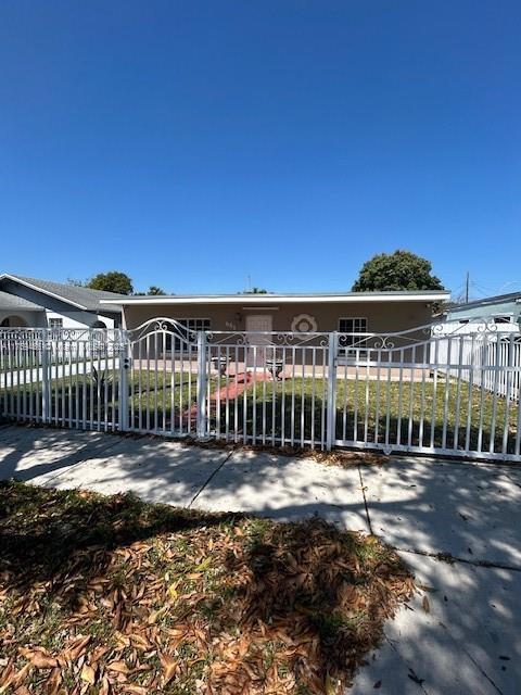 view of front facade with a fenced front yard and a gate