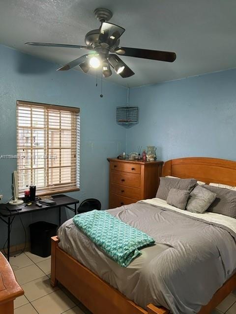 bedroom featuring light tile patterned floors and ceiling fan