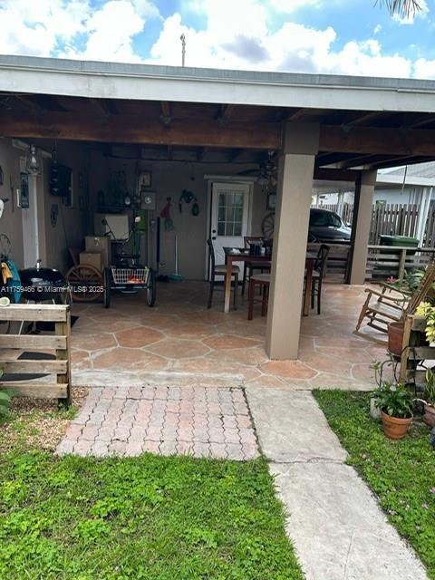 view of patio / terrace featuring outdoor dining area and fence