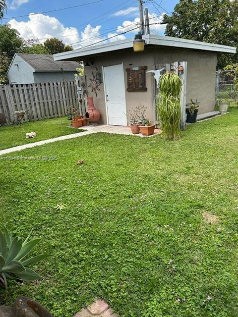 view of outdoor structure with fence