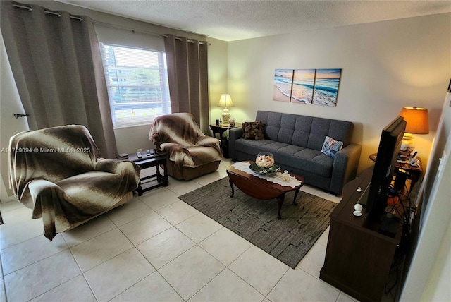 living area with light tile patterned floors and a textured ceiling