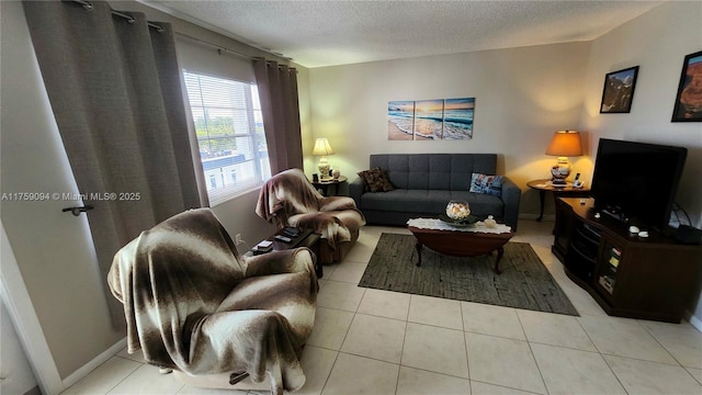 tiled living room with a textured ceiling and baseboards