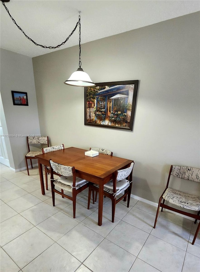 dining area with light tile patterned floors and baseboards