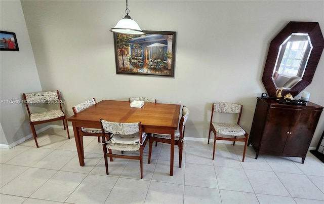 dining room featuring baseboards and light tile patterned floors