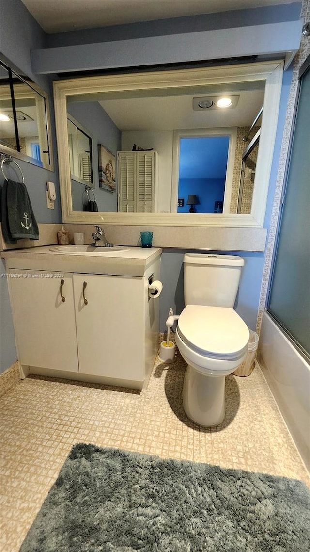 full bathroom with shower / bath combination with glass door, vanity, and toilet