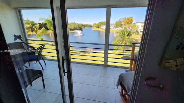 doorway to outside with a water view and tile patterned floors