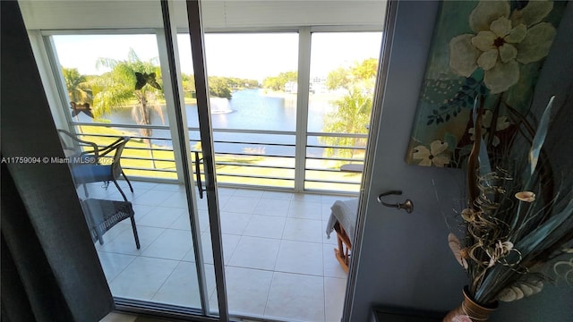 doorway featuring a water view and tile patterned floors