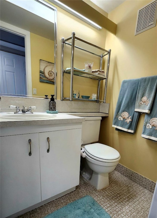 bathroom featuring visible vents, vanity, and toilet