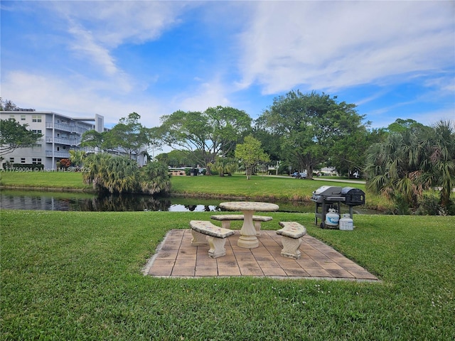 view of yard with a water view and a patio