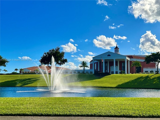 view of community featuring a lawn and a water view