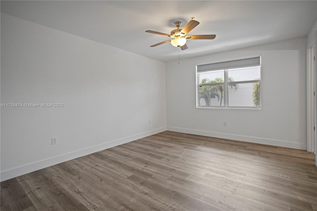 unfurnished room with baseboards, ceiling fan, and wood finished floors