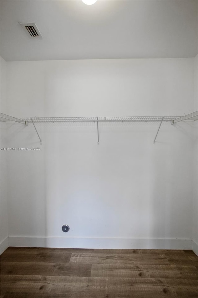 walk in closet with dark wood-style floors and visible vents