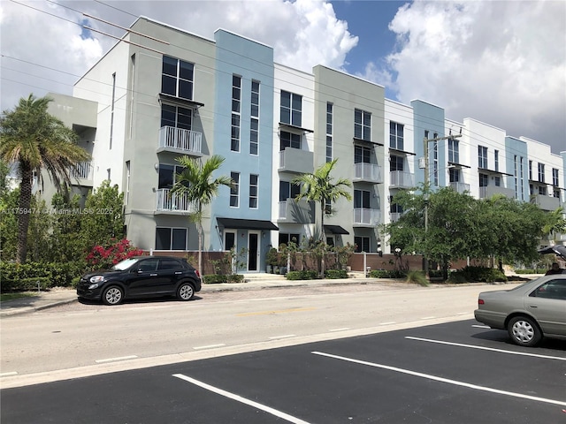 view of building exterior featuring uncovered parking