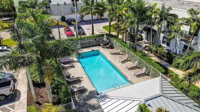 community pool with fence and a patio
