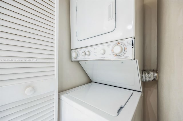 laundry area with stacked washer / drying machine and laundry area