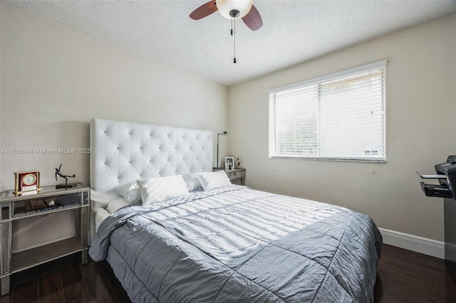 bedroom with a textured ceiling, ceiling fan, wood finished floors, and baseboards