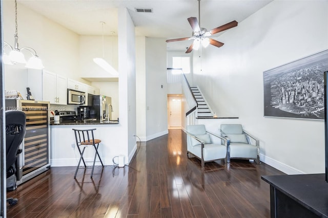 interior space with visible vents, dark wood finished floors, baseboards, and stairs