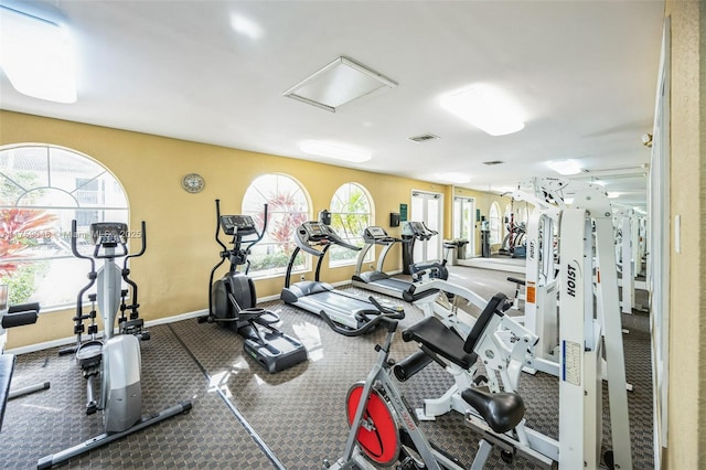 exercise room with visible vents and baseboards