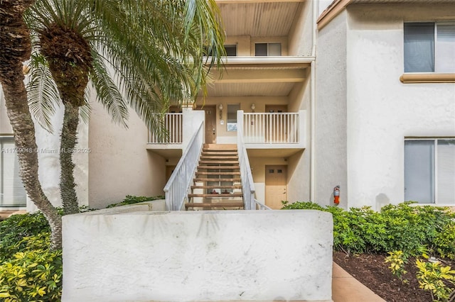 property entrance with stucco siding