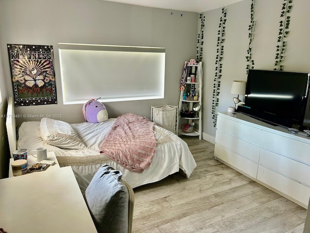 bedroom featuring light wood-style flooring