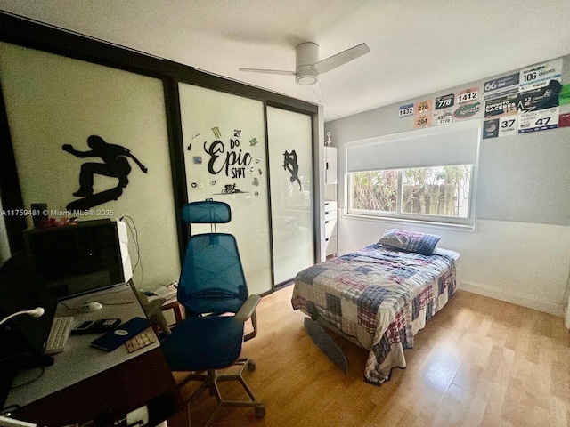 bedroom featuring ceiling fan, a closet, and wood finished floors