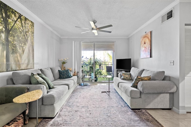 living area featuring a ceiling fan, a textured ceiling, visible vents, and crown molding