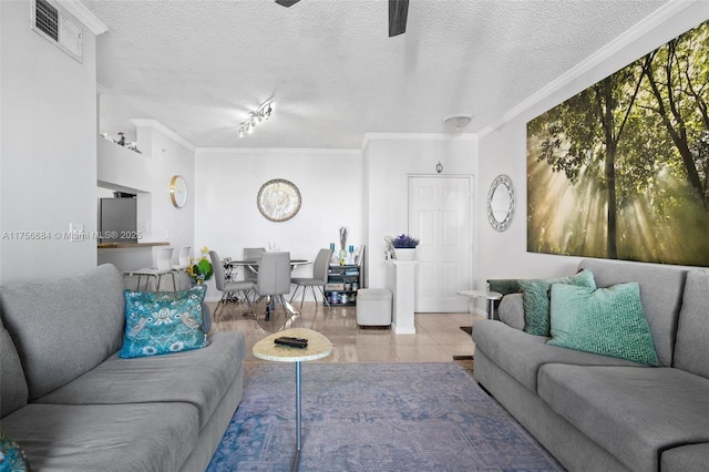 living area featuring crown molding, visible vents, a ceiling fan, a textured ceiling, and tile patterned floors