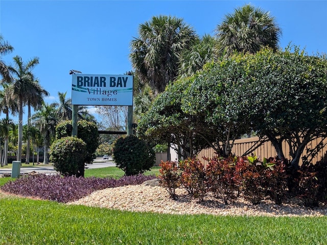 community / neighborhood sign featuring fence