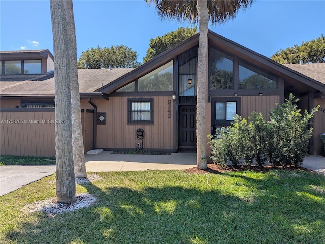 view of front of house with a front yard, fence, and a garage