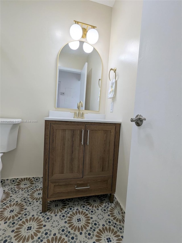 bathroom featuring toilet, vanity, and tile patterned floors