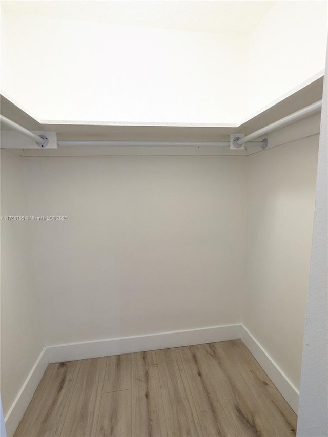 spacious closet with light wood finished floors